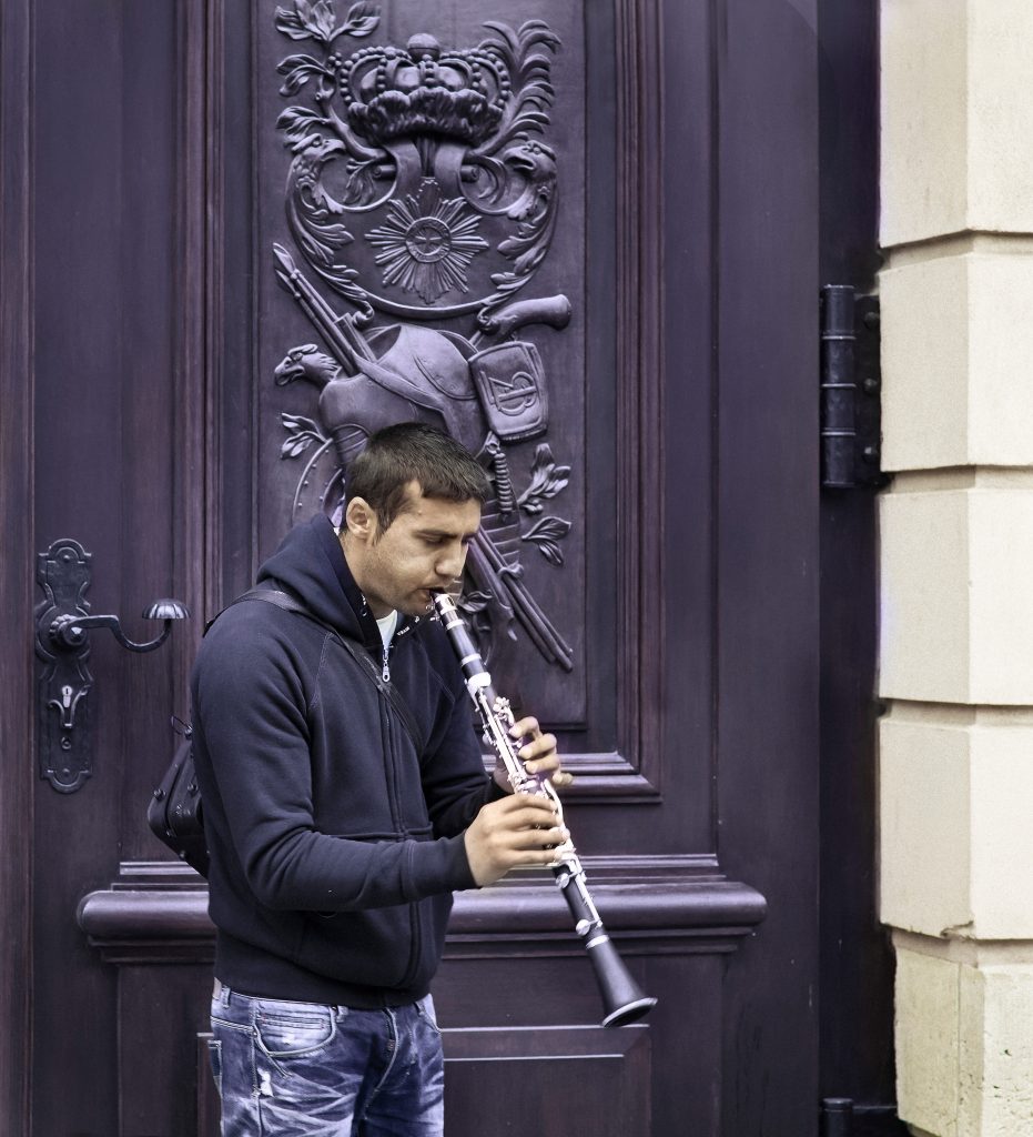 Man Playing Clarinet near Park